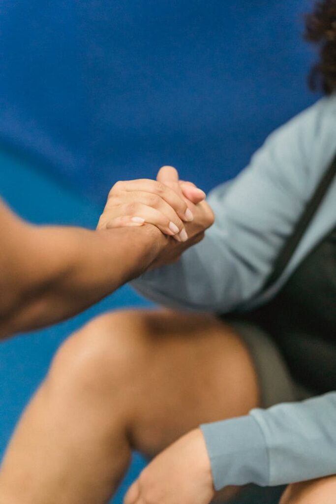 pexels-photo-6456291 A close-up of a supportive handshake between two women in a gym setting, promoting wellness.